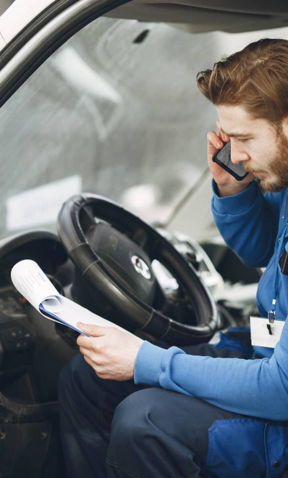 Man in the truck. Guy in a delivery uniform. Man with clipboard.